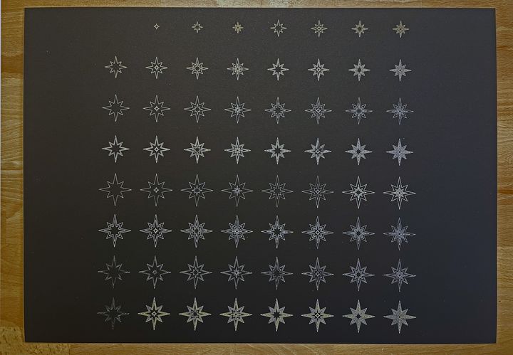Binary Christmas stars, gold on black, A3